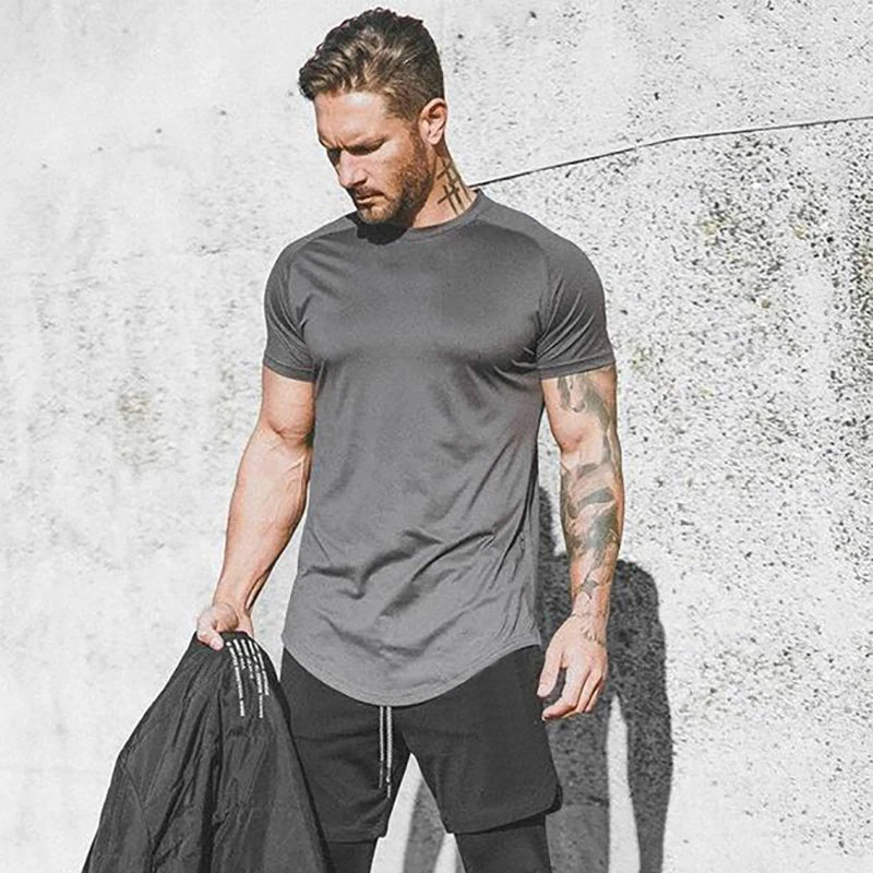 Camiseta Slim Masculina para Academia, esta camiseta slim é ideal para suas sessões de academia! Com seu tecido respirável e secagem rápida, você terá muito mais conforto e eficiência em seus treinos de musculação e fitness. Sinta-se poderoso e confiante enquanto alcança seus objetivos com essa camiseta de alta qualidade!